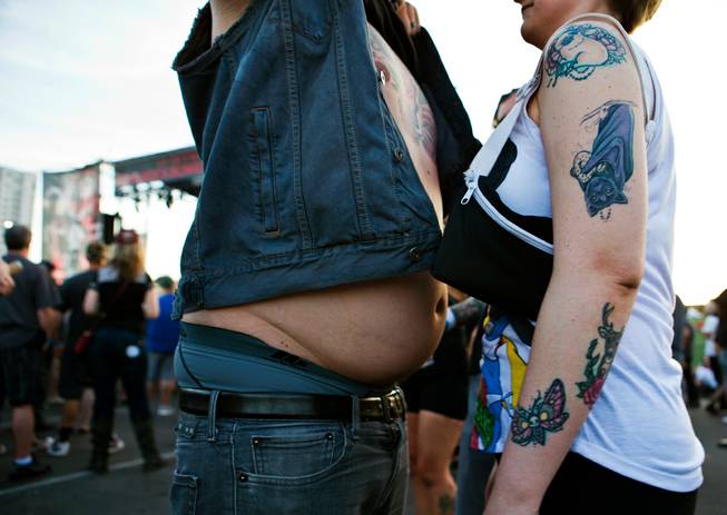 Attendees bump bellies in a distinctive greeting during the Punk Rock Bowling & Music Festival in Downtown Las Vegas on Saturday, May 28, 2016.