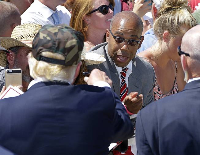 In this photo taken Friday, June 3, 2016, Republican presidential candidate Donald Trump, left, talks to Gregory Cheadle as he leaves a campaign rally at the Redding Municipal Airport, in Redding, Calif. Cheadle, whom Trump singled out while calling him "my African-American," said Monday that he is now the target of harsh criticism.
