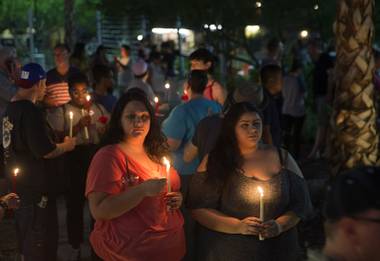 Tamara Crevison and Megan Ortiz hold candles during a vigil and call to action at the Gay & Lesbian Community Center of Southern Nevada on Sunday, June 12, 2016, in Las Vegas. The event was a show of solidarity and support after Sunday morning’s mass shooting at Pulse nightclub in Orlando, Fla., where at least 50 patrons were killed and 53 injured.