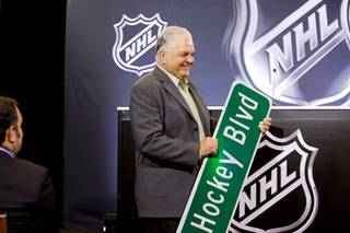 Clark County Commission Chairman Steve Sisolak arrives with customized road signs at a NHL news conference at the Encore Wednesday, June 22, 2016. Sisiolak gave a sign to new franchise owner Bill Foley, left, and NHL Commissioner Gary Bettman, he said.