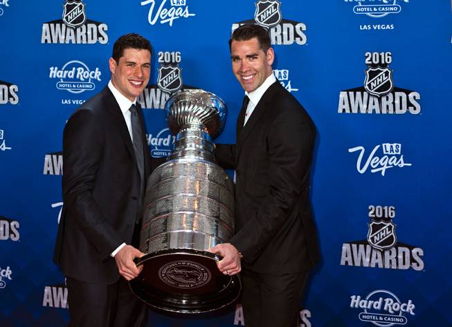 Sidney Crosby and Pascal Dupuis hoist the Stanley Cup on the red carpet of the 2016 NHL Awards at the Joint on Wednesday, June 22, 2016, at the Hard Rock Hotel.
