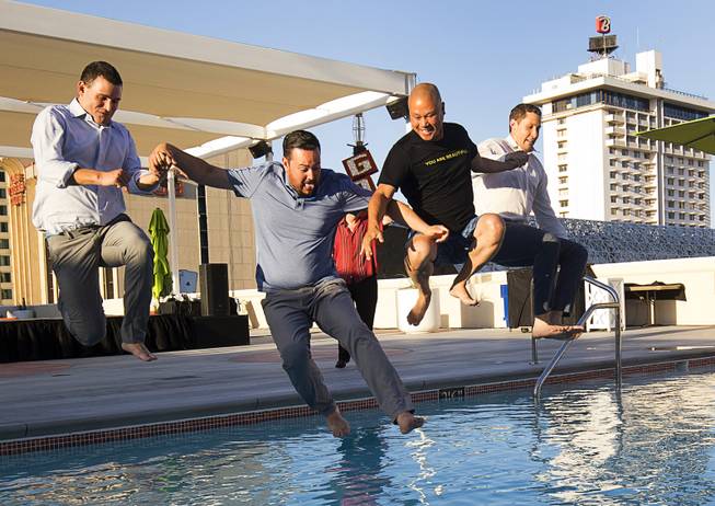 Taking a plunge into the new rooftop pool, from left, Roy Zabludowicz, Sam Cherry, Tony Hsieh, and Jonathan Jossel, during a preview event for the new rooftop pool at the Plaza in downtown Las Vegas Thursday, June 23, 2016. The pool officially opens on July 2.
