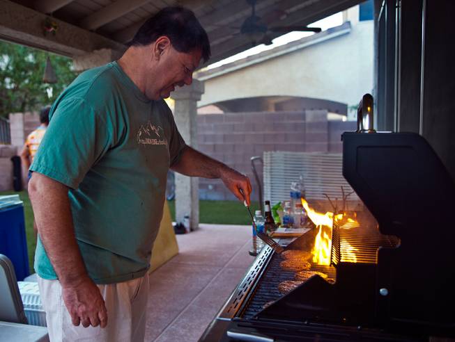Bob Tatalovich grills up some burgers for son Michael Tatalovich and other inverted guests while Texas 4000 take a rest step at the home in Henderson on Thursday, June 23, 2016.  Michael, a cancer survivor, is joined by other University of Texas at Austin riders doing a 4,000-mile, 70-day cycling tour through North America.