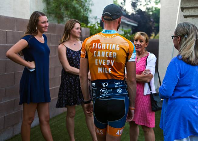 Cancer survivor Michael Tatalovich, 20, talks with family and friends during a rest step at his parent's home in Henderson on Thursday, June 23, 2016.  He is joined by other Texas 4000 of University of Texas at Austin riders doing a 4,000-mile, 70-day cycling tour through North America.