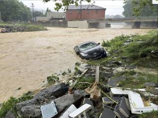 In this photo released by the The Weather Channel, a vehicle rests on the in a stream after a heavy rain near White Sulphur Springs, W.Va., Friday, June 24, 2016. Multiple fatalities have been reported in flooding that has devastated parts of the state, a state official said Friday morning.