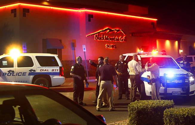 Henderson Police officers and investigators confer after a shooting near the Black Mountain Grill in Henderson Monday, June 27, 2016.