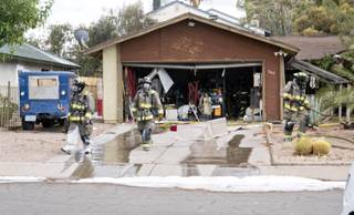Fire crews finish putting out a house fire on Zuber Avenue near Boulder Highway and Warm Springs Road that spread to a neighboring house and RV, parked in its drive way, midafternoon on Tuesday, June 28, 2016.