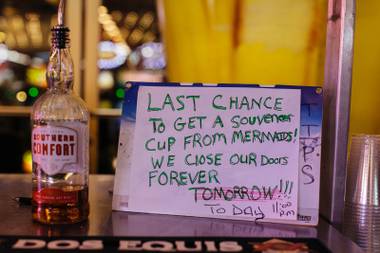 A handwritten sign adorns a bar outside Mermaids, during the last night of operation on Monday, June 27, 2016. The casino closed its doors at eleven along with La Bayou and Glitter Gulch.