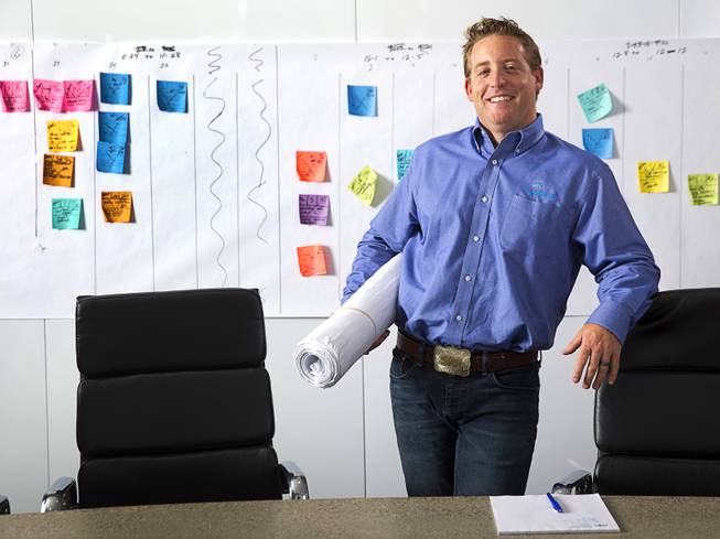 Bret Loughridge, vice president of operations for SR Construction, poses in front of a project's pull planning schedule at the company's offices Tuesday, June 28, 2016. 