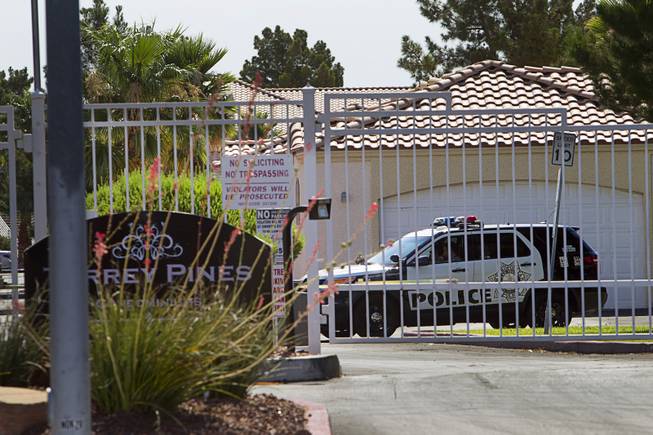 A Metro Police vehicle is shown behind the gates of the Torrey Pines Condominiums Thursday, June 30, 2016. On Wednesday night, a man shot and killed his three children and himself at their home inside the complex, The wife, also shot and killed by the husband, was found a few blocks from their home at a Walgreens parking lot on Lake Mead and Jones boulevards. 