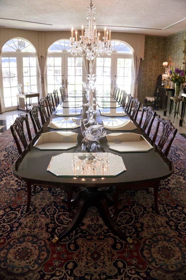 Mirror table settings for eighteen decorate the dinning table inside Phyllis McGuire's 65,000 square foot mansion located in Rancho Circle, Tuesday, June 14, 2016. The estate went up for sale in July. 