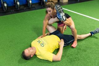 Dr. Andrew Cash and Nancy Dickenson, endurance coach and movement specialist, run through PNF stretching while working on the mobility portion of a fitness routine at Anthem Fitness in Henderson June 24, 2016.