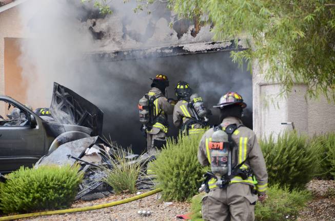 A garage fire was stopped by firefighters before spreading further into a two-story Henderson home located on the 1100 block of Cottonwood Ranch Court, near the intersection of Sandy Ridge Avenue and Summit Grove Drive, Friday morning, July 1, 2016.