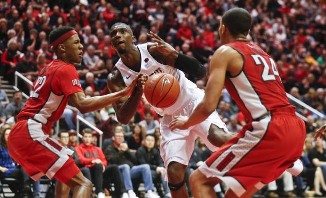San Diego State forward Winston Shepard is stripped of the ball while driving the lane against UNLV's Patrick McCaw, left, and Jalen Poyser during the first half of a NCAA college basketball game Saturday, March 5, 2016, in San Diego.