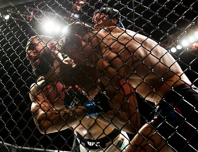 Welterweight fighter Belal Muhammad and Alan Jouban tangle on the fence during the UFC Fight Night action at the MGM Grand Garden Arena on Thursday, July 7, 2016.   .