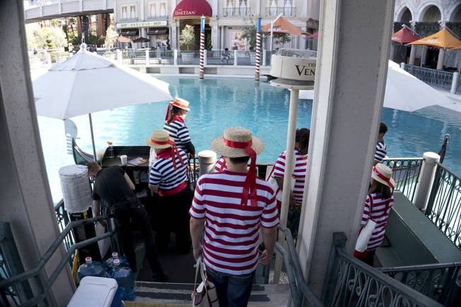 Students board a gondola during a "Gondola Rowing 101" class as part of the Gondola University attraction at The Venetian Hotel & Casino, Thursday, July 7, 2016.