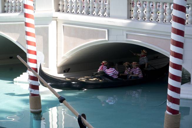 Master Gondolier Tino, standing, takes students on a gondola ride during a "Gondola Rowing 101" class as part of the Gondola University attraction at The Venetian Hotel & Casino, Thursday, July 7, 2016.
