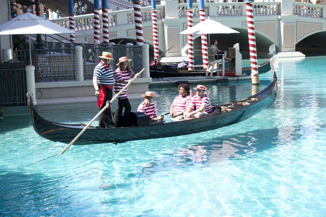 Sally Damian steers the gondola with the help of Master Gondolier Tino during a "Gondola Rowing 101" class as part of the Gondola University attraction at The Venetian Hotel & Casino, Thursday, July 7, 2016.
