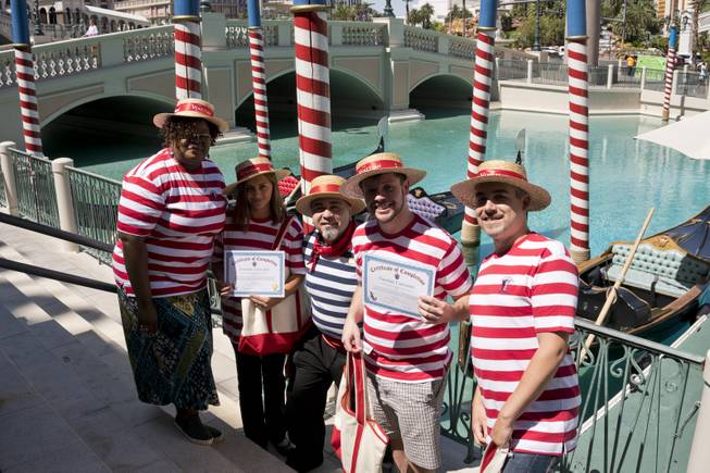 From left, Augusta Washington, Sally Damian, Master Gondolier Tino, Las Vegas Weekly reporter Mark Adams, and James Lungi pose for a photo after receiving their gondolier certificates during a "Gondola Rowing 101" class as part of the Gondola University attraction at The Venetian Hotel & Casino, Thursday, July 7, 2016.