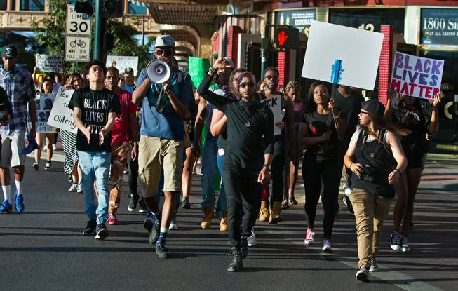 Supporters walk along Main Street as the Black Lives Matter organization holds another protest and march in downtown Las Vegas on Saturday, July 16, 2016.