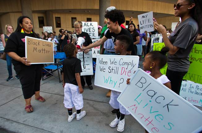 A young supporter chants for the crowd as the Black Lives Matter organization holds another protest and march in downtown Las Vegas on Saturday, July 16, 2016.