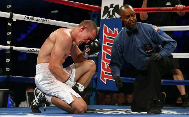 Tommy Karpency attempts to get the blood away from his eye as the referee Kenny Bayless looks to opponent Oleksandr Gvozdyk during a light heavyweight fight at the MGM Grand Garden Arena on Saturday, July 23, 2016. 