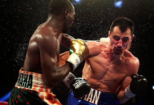 WBO junior welterweight champion Terence Crawford, left, trades blows with WBC champion Viktor Postol during their title unification fight at the MGM Grand Garden Arena on Saturday, July 23, 2016.