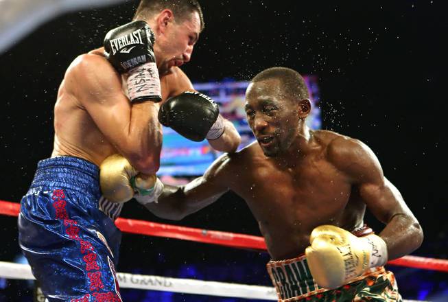 WBC junior welterweight champion Viktor Postol, left, and WBO champion Terence Crawford exchange blows during their title unification fight at the MGM Grand Garden Arena on Saturday, July 23, 2016.