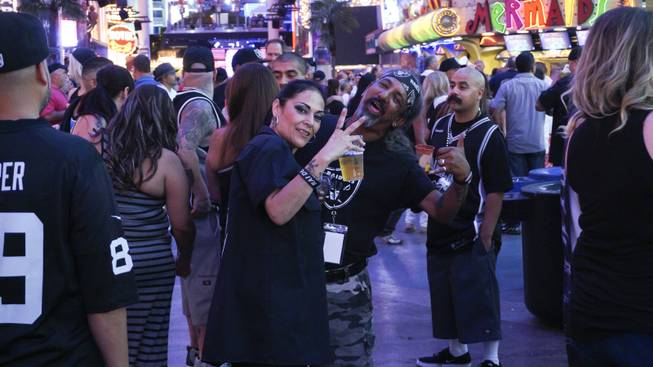 Oakland Raiders fans were decked out in team garb for the Raider Nation-hosted pub crawl in downtown Las Vegas on Friday, July 22, 2016.