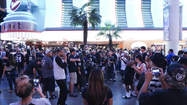 NFL Raiders fans took photos with each other during a Raider Nation hosted pub crawl in Downtown Las Vegas Friday, July 22, 2016.