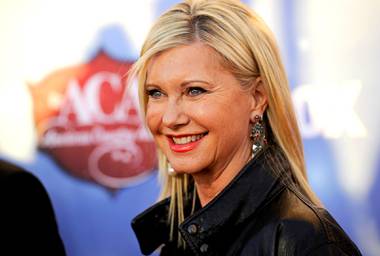 In this Tuesday, Dec. 10, 2013, file photo, Olivia Newton-John arrives at the American Country Awards at Mandalay Bay in Las Vegas. 