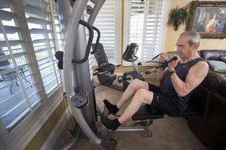 Dr. Jeffrey Cummings works out in his home gym in Henderson, Sunday, July 3, 2016.