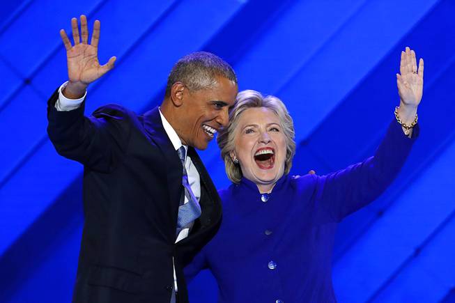 President Barack Obama and Democratic Presidential nominee Hillary Clinton wave to delegates after President Obama's speech during the third day of the Democratic National Convention in Philadelphia , Wednesday, July 27, 2016. (AP Photo/J. Scott Applewhite)