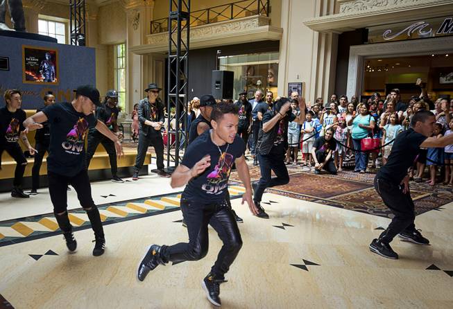 Cast members of "Michael Jackson One" perform during an unveiling ceremony in the Mandalay Bay lobby Thursday, July 28, 2016. The 10-foot-tall statue is on loan from the Estate of Michael Jackson.