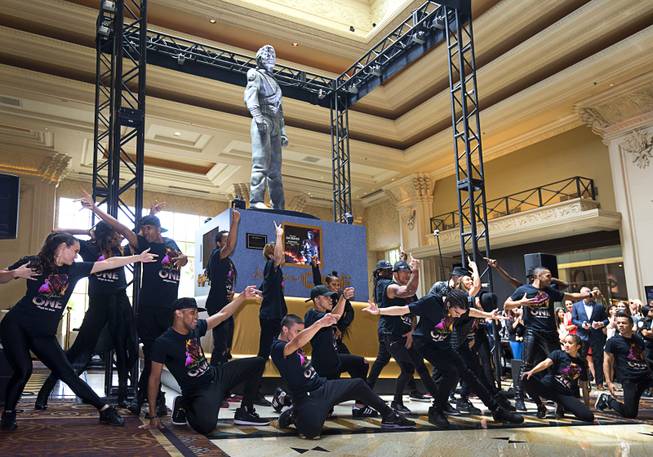 Cast members of "Michael Jackson One" pose during an unveiling ceremony in the Mandalay Bay lobby Thursday, July 28, 2016. The 10-foot-tall statue is on loan from the Estate of Michael Jackson.