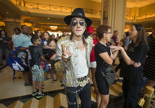 Pablo Santana, a local Michael Jackson tribute artist, poses, following a Michael Jackson statue unveiling ceremony in the Mandalay Bay lobby Thursday, July 28, 2016. The 10-foot-tall statue is on loan from the Estate of Michael Jackson.
