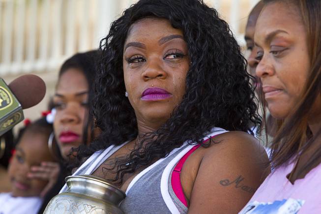 Jacqueline Elder, center, mother of Morland Antwon Richey-Elder, cries during a news conference Thursday, July 28, 2016. Elder was 20-years-old when he was shot and killed at a house party on July 28, 2014. The case is still unsolved.