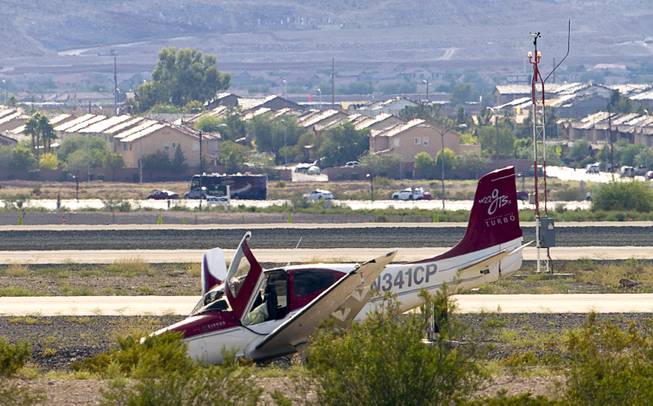 A small plane is is shown in the desert after a crash-landing short of the runway at the Henderson Executive Airport in Henderson Thursday, July 28, 2016. No one was injured in the accident, officials said.