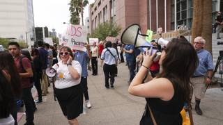 Protesters speak into megaphones during a rally against the ESA voucher program prior to the start of the Nevada Supreme Court hearing on Senate Bill 302 at the Regional Justice Center in Las Vegas, Friday, July 29, 2016.