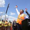 Wynn Boston Harbor President Robert DeSalvio, left, and Everett Mayor Carlo DeMaria, right, sound horns to signal an official start of construction as workers look on, left, at the site of the Wynn Boston Harbor resort casino complex, Thursday, Aug. 4, 2016, in Everett, Mass. Wynn Resorts is starting construction on its $2 billion Boston-area casino after years of legal fights. 