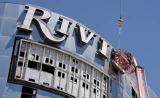 The last of the neon signage is removed from the  remaining structures of the Riviera Hotel & Casino as demolition continues in Las Vegas on Wednesday, Aug. 10, 2016. The implosion of the final tower at the Riviera Hotel & Casino is scheduled for the early  morning of Tuesday, August 16. 