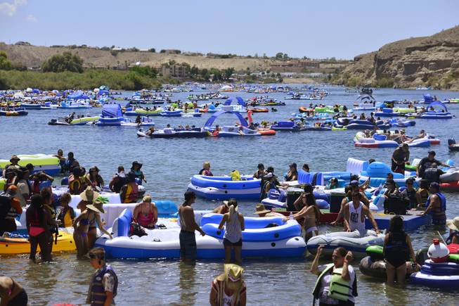 Participants float along on the Colorado River as part of the Laughlin River Regatta Saturday, Aug. 13, 2016. The popular event is returning this weekend after being canceled last year over concerns about trash left behind.