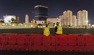 Gino Catania, left, and his cousin Vinny Catania wait on a barrier for the implosion of the remaining tower of the Riviera Hotel & Casino, far left, along with the property's remaining structures early Tuesday August 16, 2016 in Las Vegas. Northstar Contracting Group held an employee event for the implosion in the adjoining Gold parking lot of the Las Vegas Convention Center. CREDIT: Mark Damon/Las Vegas News Bureau