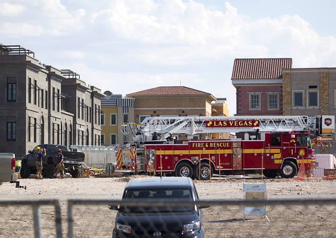 A Las Vegas Fire ladder truck leaves a Tivoli Village construction site Monday, Aug. 22, 2016. One person was killed in a scaffolding collapse at the site, police said.