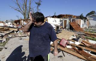 Mark Martinez wipes his face after speaking with Republican vice presidential candidate, Indiana Gov. Mike Pence, Thursday, Aug. 25, 2016, in Kokomo, Ind. Martinez home was hit by a tornado that passed through the area Wednesday afternoon. 