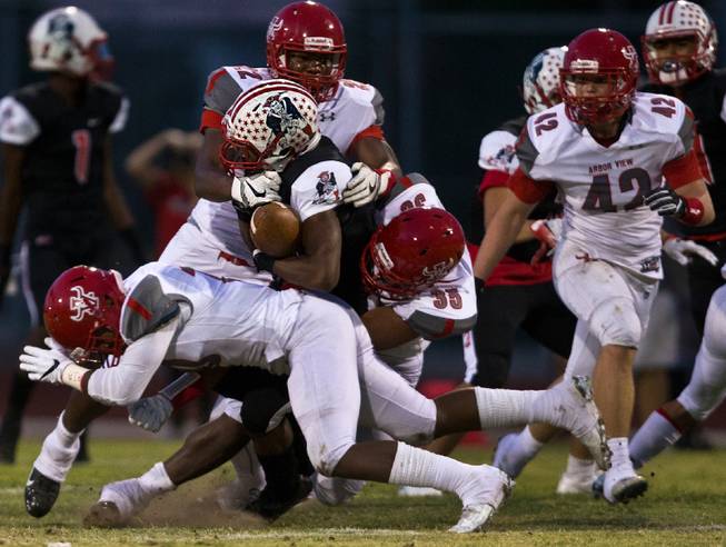 Arbor View defenders gang tackle a Liberty runner and will cause a fumble reception during their season opener on Friday, August 26, 2016.
