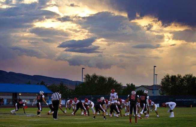 Storm clouds build in the distance and will eventually delay Liberty and Arbor View during their season opener on Friday, August 26, 2016..