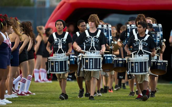 The Liberty drum corps precedes the team through their giant helmet as they face Arbor View during their season opener on Friday, August 26, 2016.