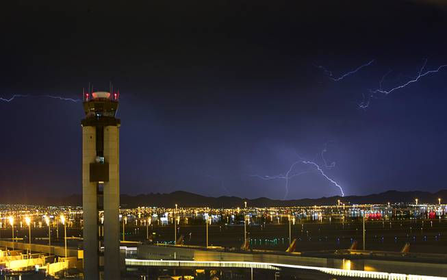 Lightning flashes south of McCarran International Airport  Friday, Aug. 26, 2016. 