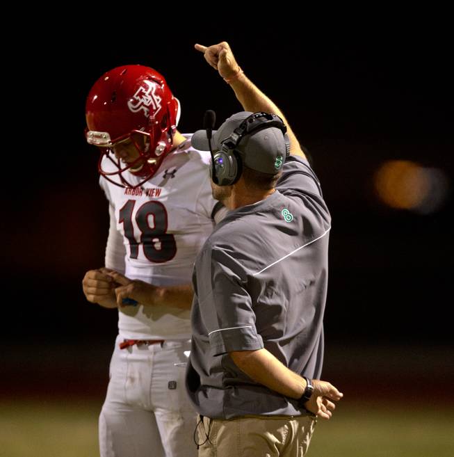 Arbor View QB Hayden Bollinger (18) gets the next play from head coach Dan Barnson during their season opener on Friday, August 26, 2016.